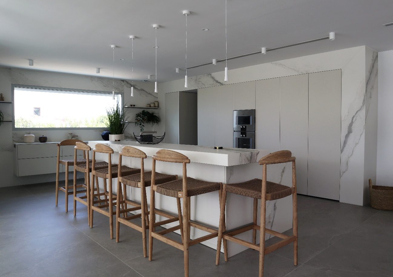Villa Mar de Japón — cocina con isla, taburetes y revestimiento de mármol
